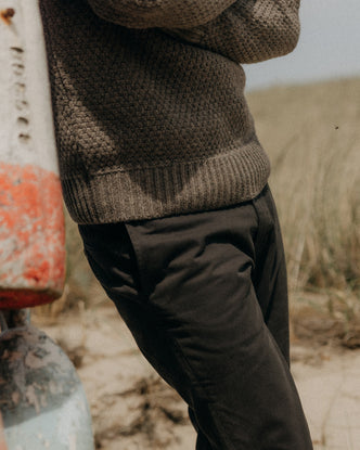 fit model standing in a field wearing The Slim Foundation Pant in Organic Faded Black