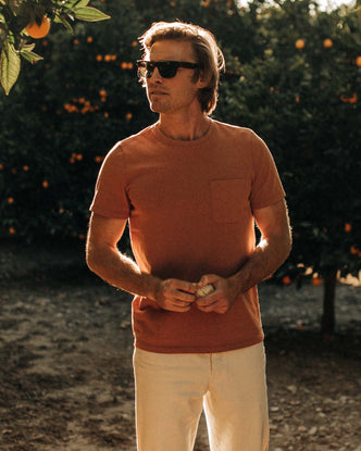 fit model wearing The Heavy Bag Tee in Apricot in an orange grove