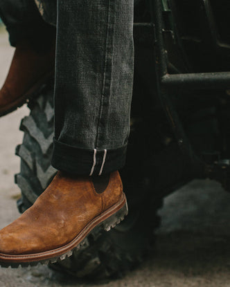 fit model wearing The Ranch Boot in Redwood Waxed Suede, looking left