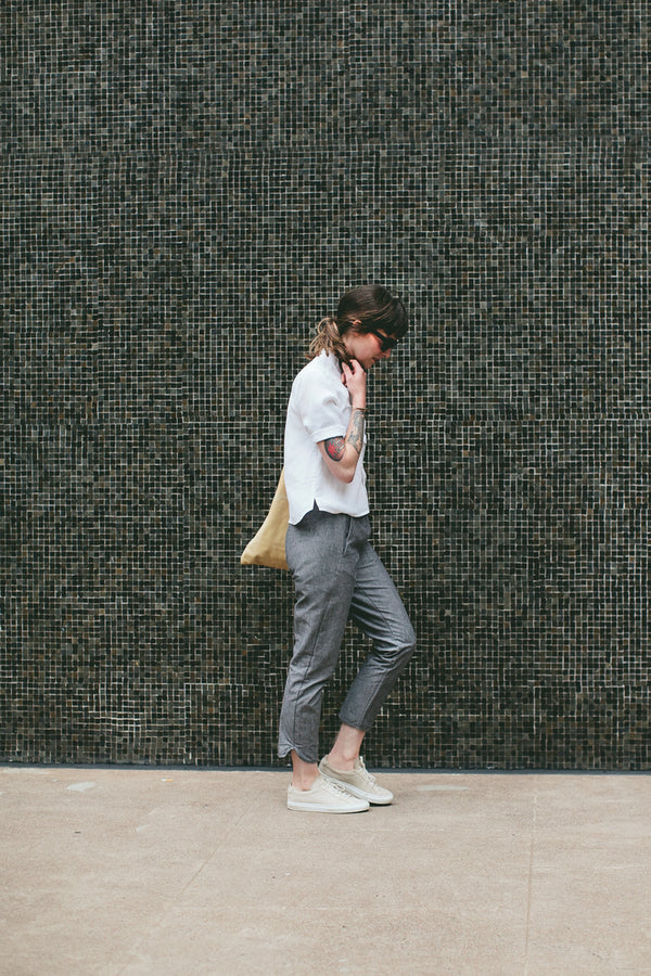 Modelling the pants - walking pas a mosaic wall.