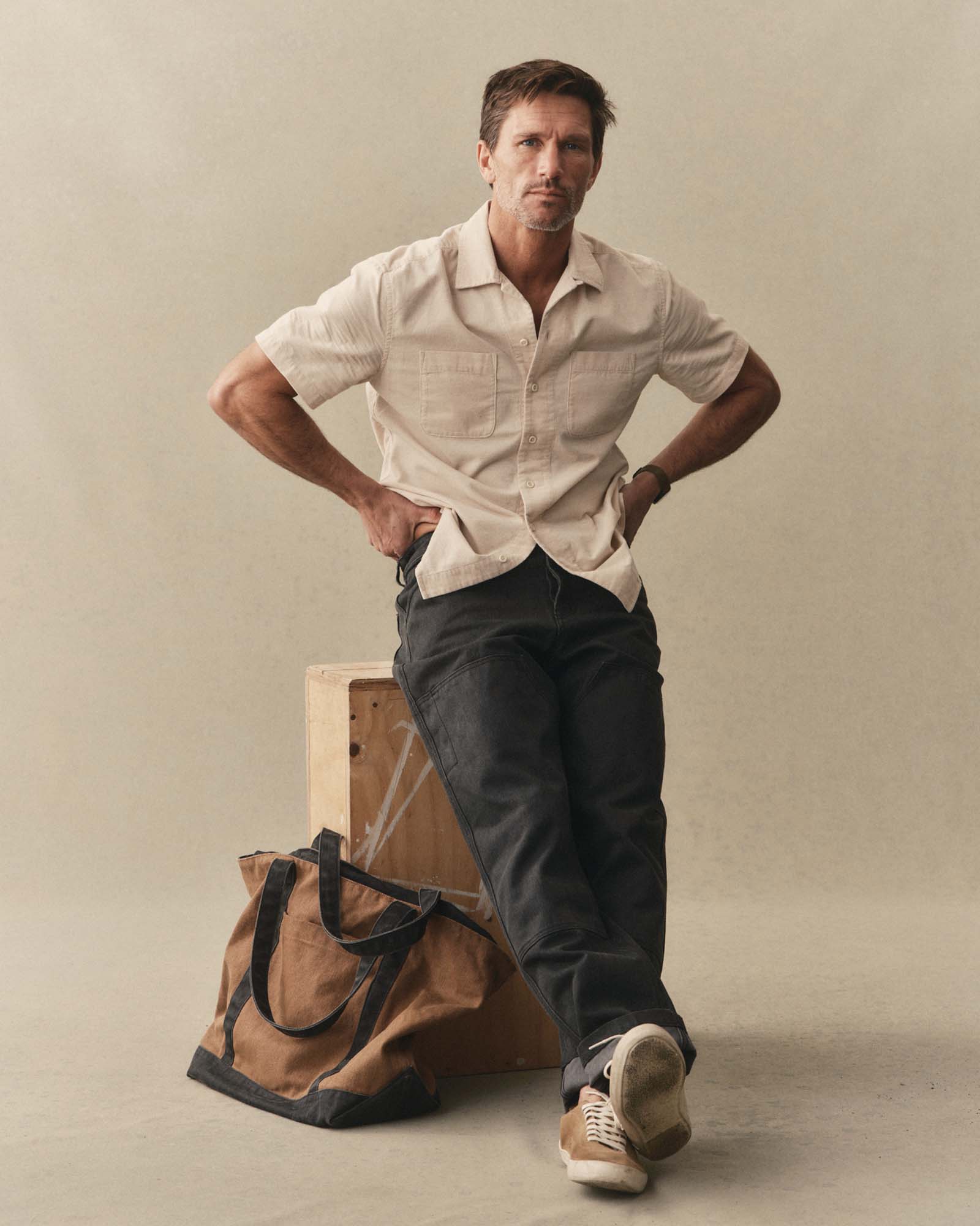 fit model sitting wearing The Conrad Shirt in Heather Oat Pincord, Wovens by Taylor Stitch