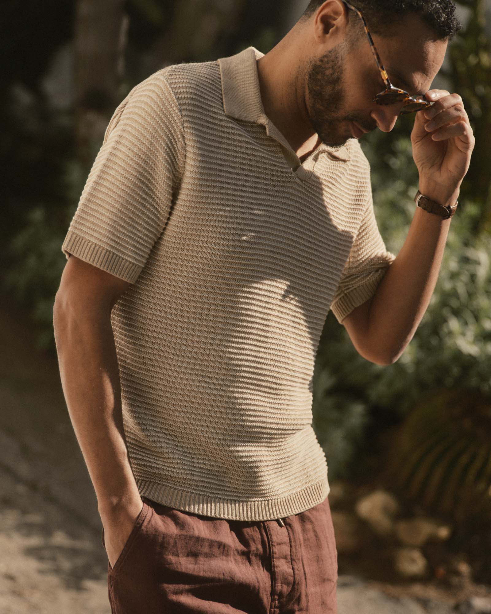 fit model posing in The Valencia Sweater Polo in Sand Stripe, Knits by Taylor Stitch