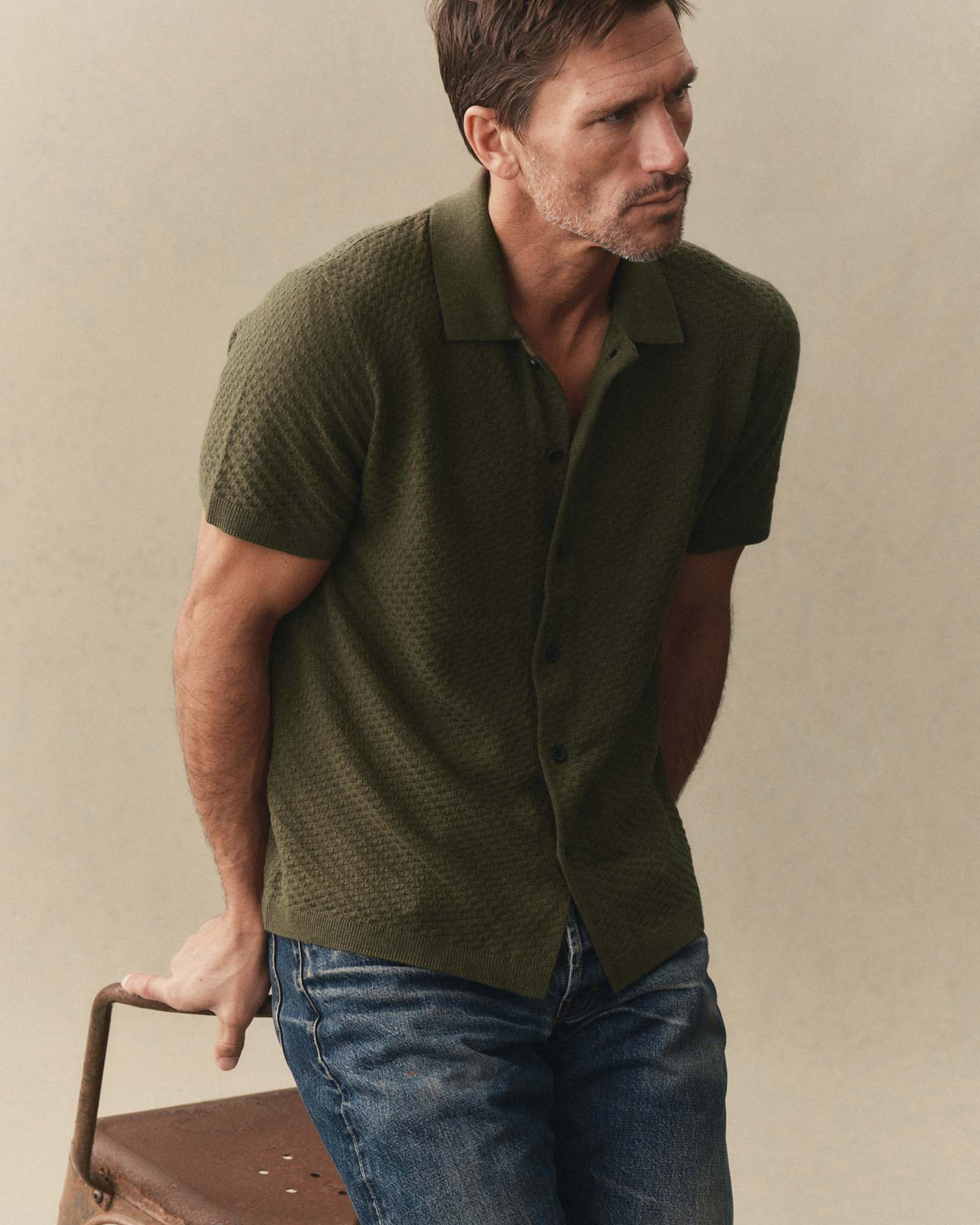 fit model sitting wearing The Arlo Sweater Polo in Cilantro Texture Knit, Knits by Taylor Stitch