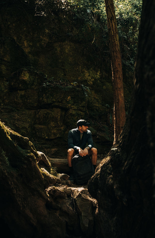 Michael Easter sitting by a trail