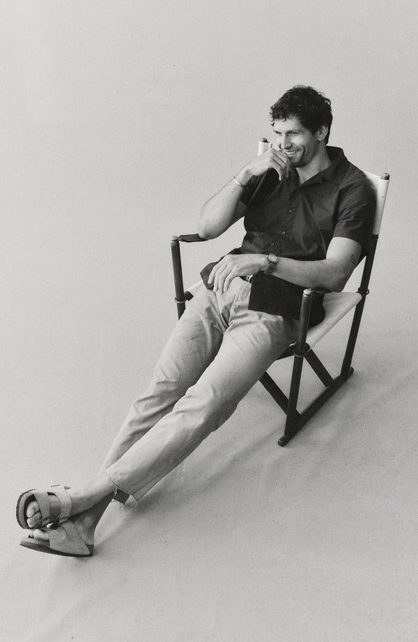 fit model sitting wearing The Davis Shirt in Navy Floral Embroidery