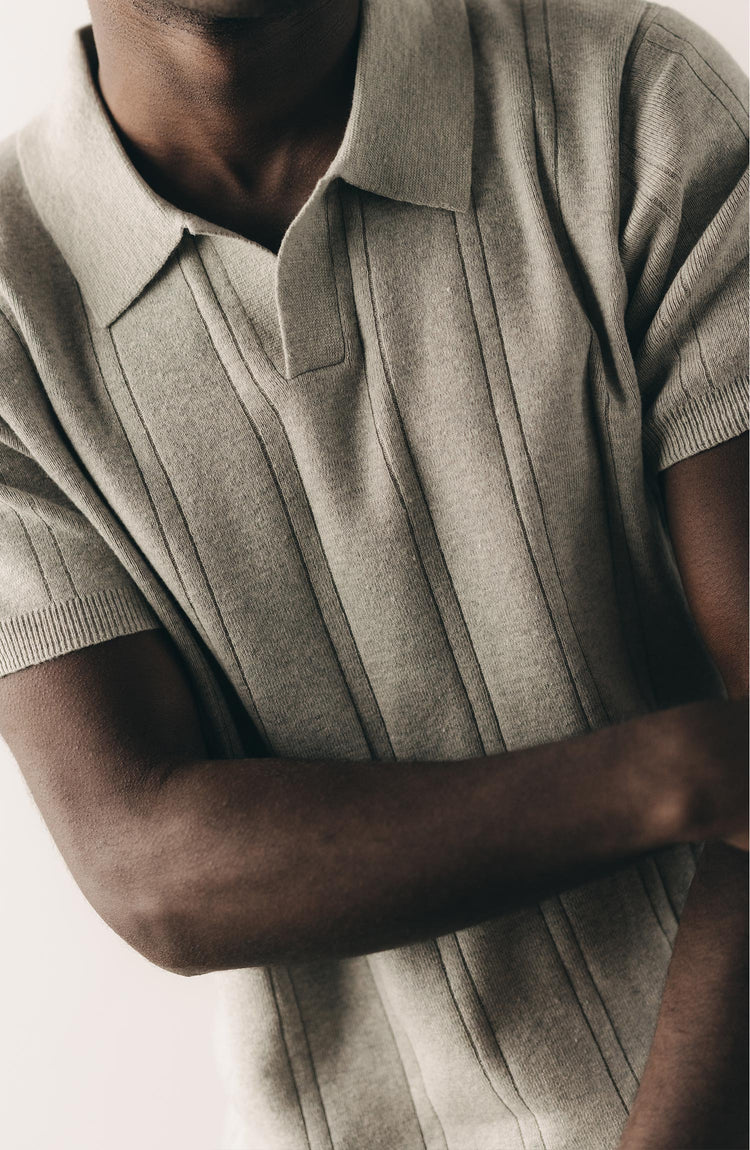 fit model posing in The Valencia Sweater Polo in Heather Grey Rib