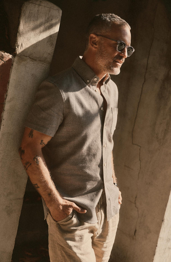 fit model leaning against the wall wearing The Short Sleeve Jack in Fern Twist Waffle