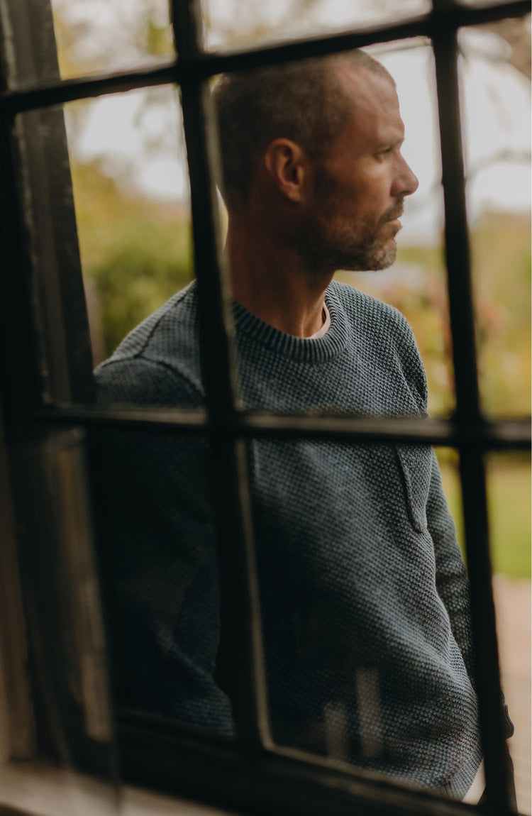 fit model posing in The Crawford Crew Sweater in Washed Indigo