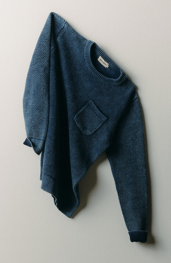 editorial image of The Crawford Crew Sweater in Washed Indigo hanging