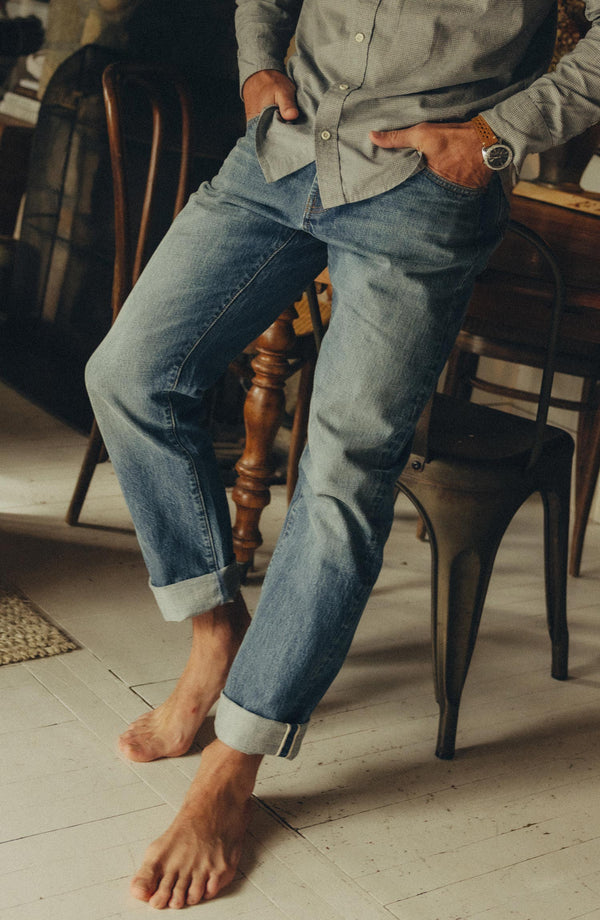fit model sitting wearing The Democratic Jean in Light Wash Organic Selvedge