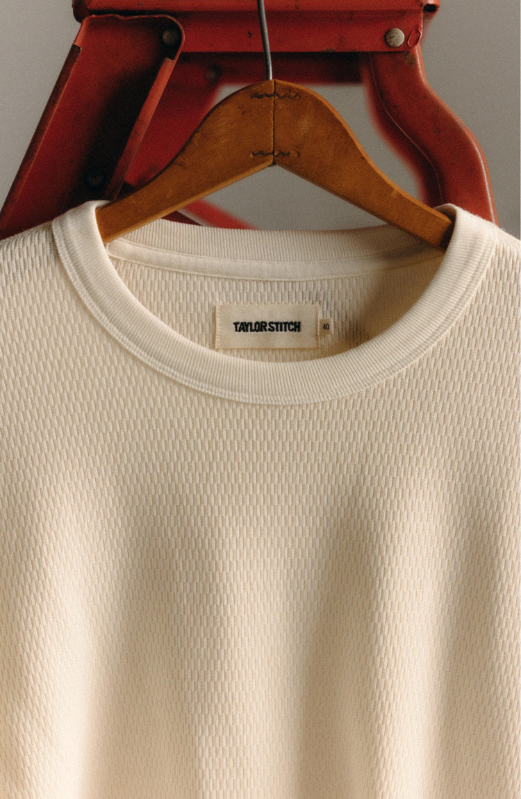 fit model sitting wearing The Organic Cotton Short Sleeve Crew in Vintage White Waffle