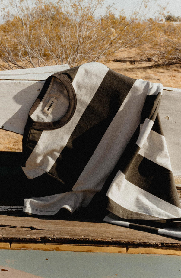 editorial flatlay of The Organic Cotton Shop Tee in Faded Black Stripe
