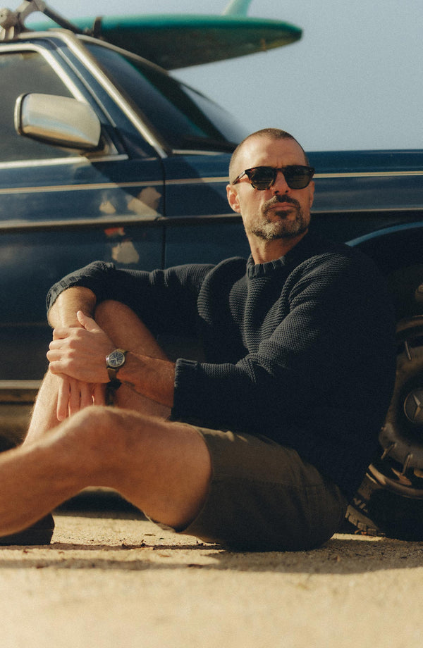 fit model sitting wearing The Boulder Short in Mushroom Ripstop