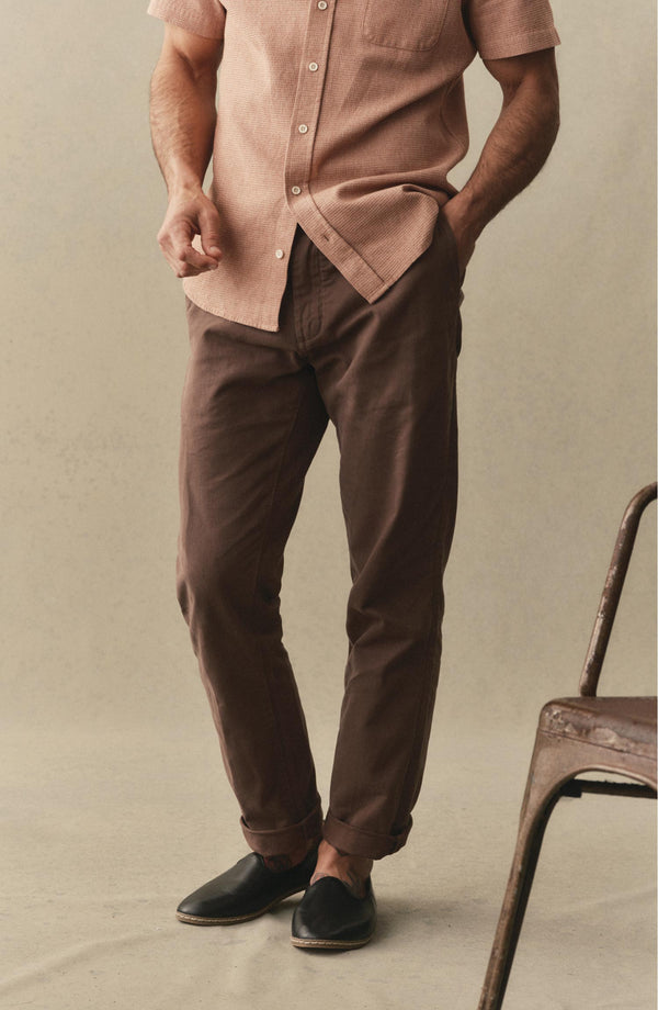 A pair of Foundation Pants folded on a black background.