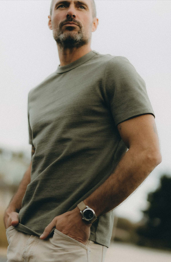fit model sitting wearing The Organic Cotton Shop Tee in Army Twist