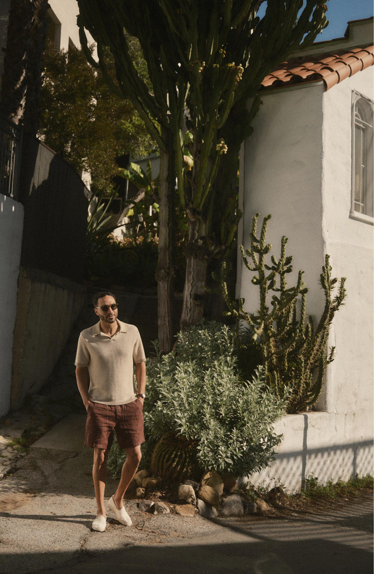 fit model posing in The Valencia Sweater Polo in Sand Stripe