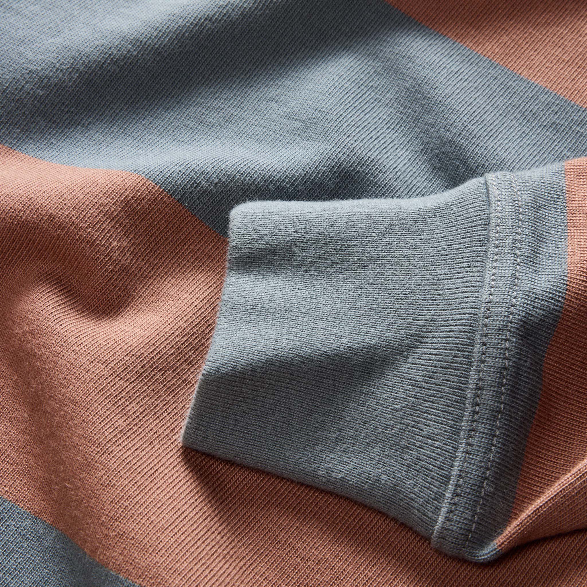material shot of the sleeves on The Rugby Shirt in Faded Brick Stripe, Knits by Taylor Stitch