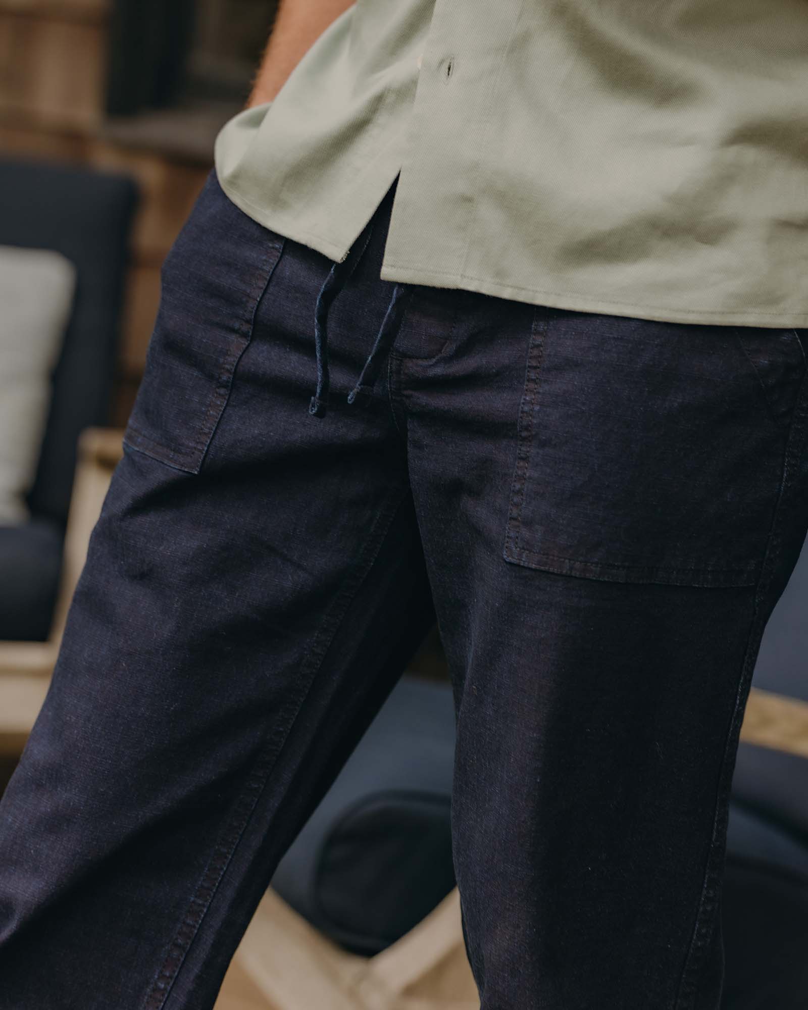 fit model showing off the pockets on The Breakwater Pant in Rinsed Indigo Ripstop, Bottoms by Taylor Stitch
