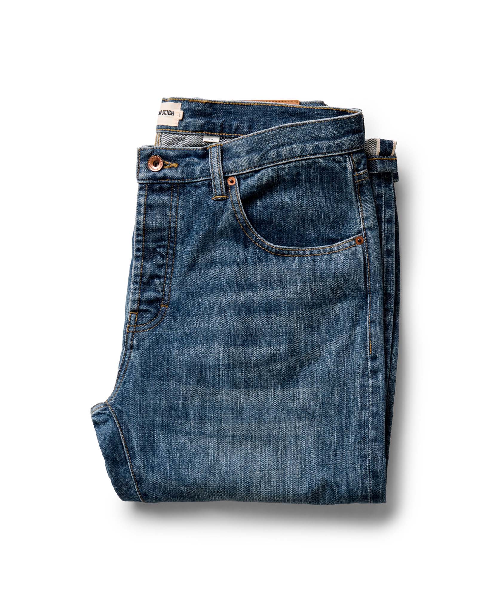 folded flatlay of The Slim Jean in Mid Wash Organic Selvedge, Bottoms by Taylor Stitch