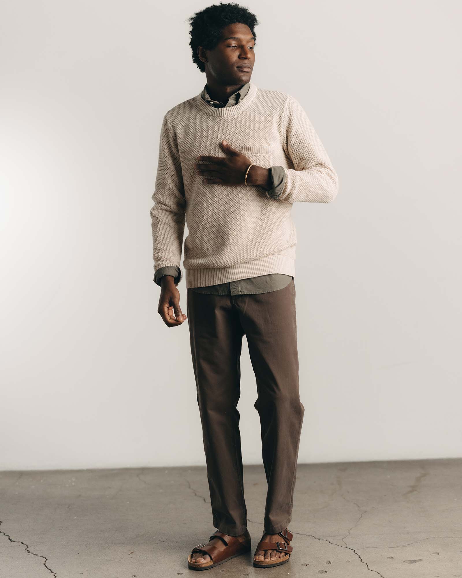 fit model posing in The Crawford Crew Sweater in Marled Natural, Knits by Taylor Stitch