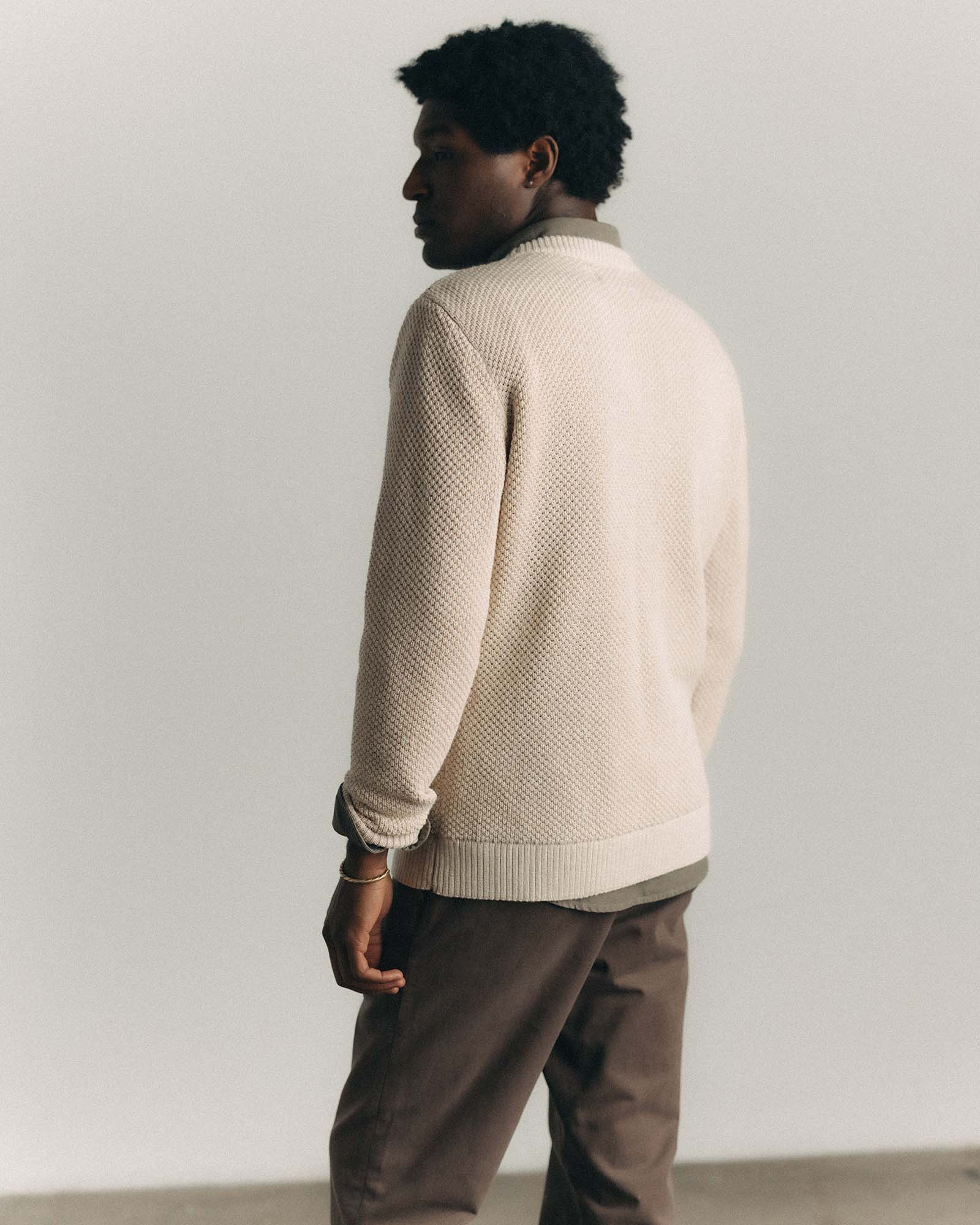fit model showing off the back of The Crawford Crew Sweater in Marled Natural, Knits by Taylor Stitch