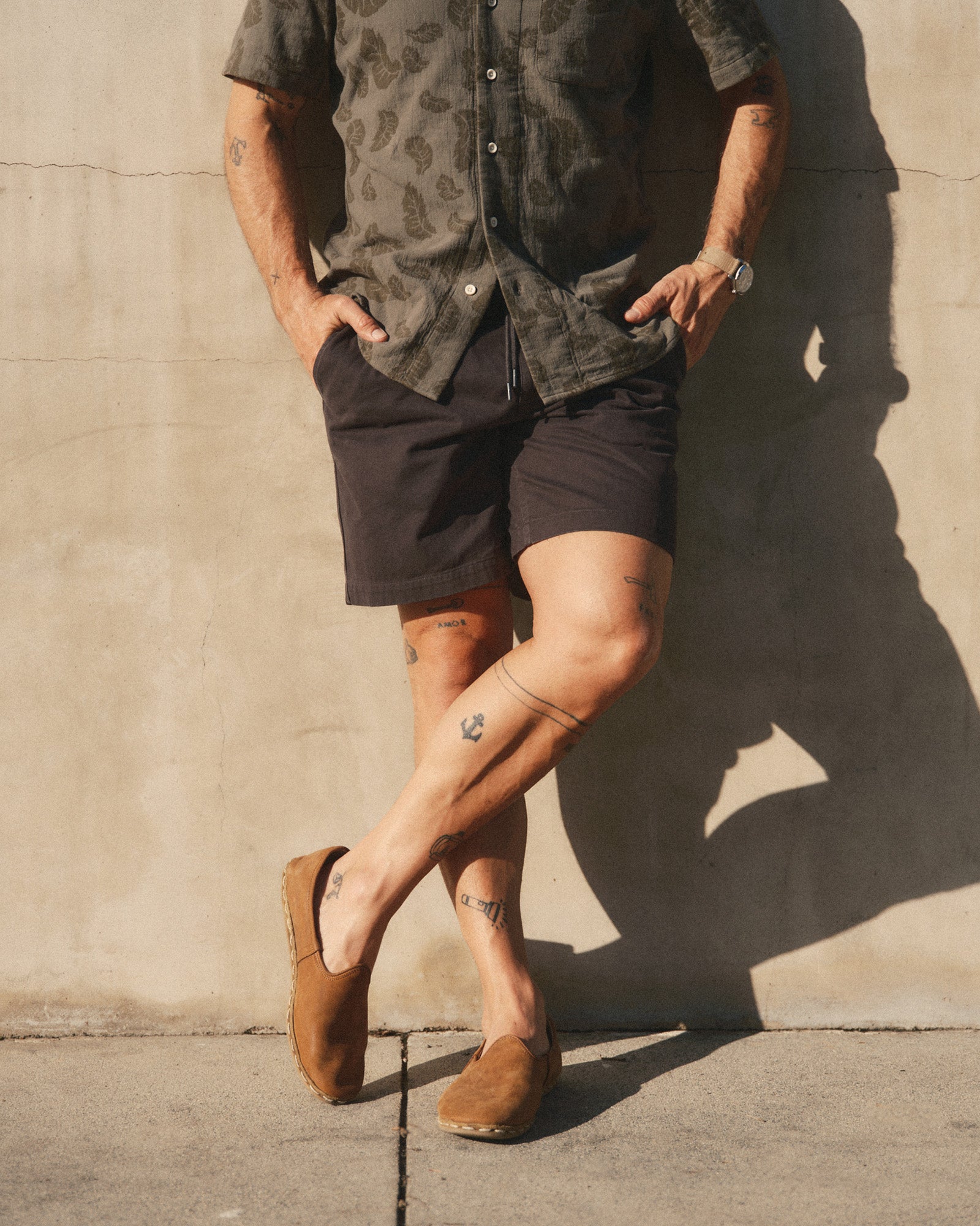 fit model posing in The Apres Short in Organic Faded Black Foundation Twill, Bottoms by Taylor Stitch