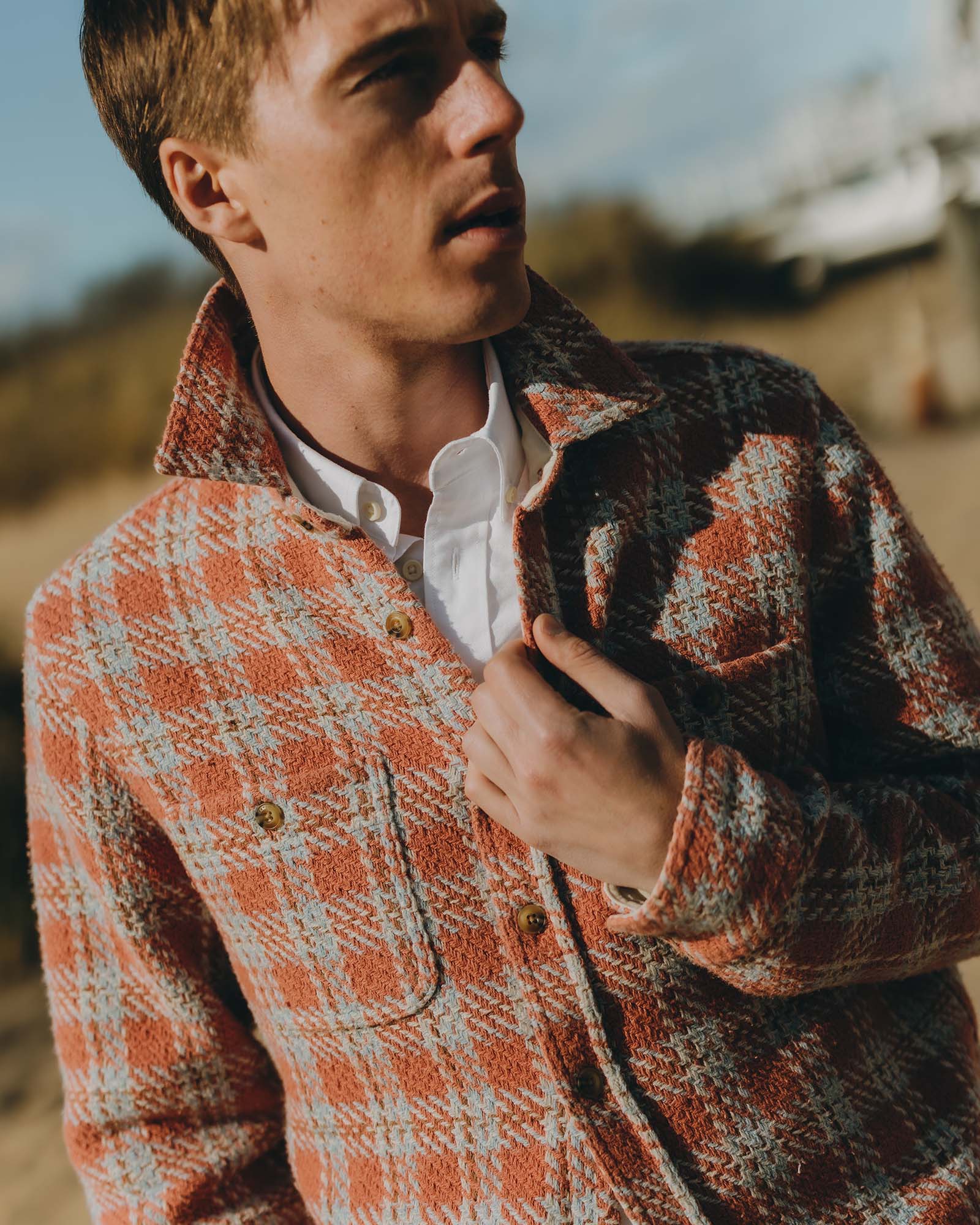 fit model posing in The Cutter Overshirt in Salmon Plaid, Wovens by Taylor Stitch