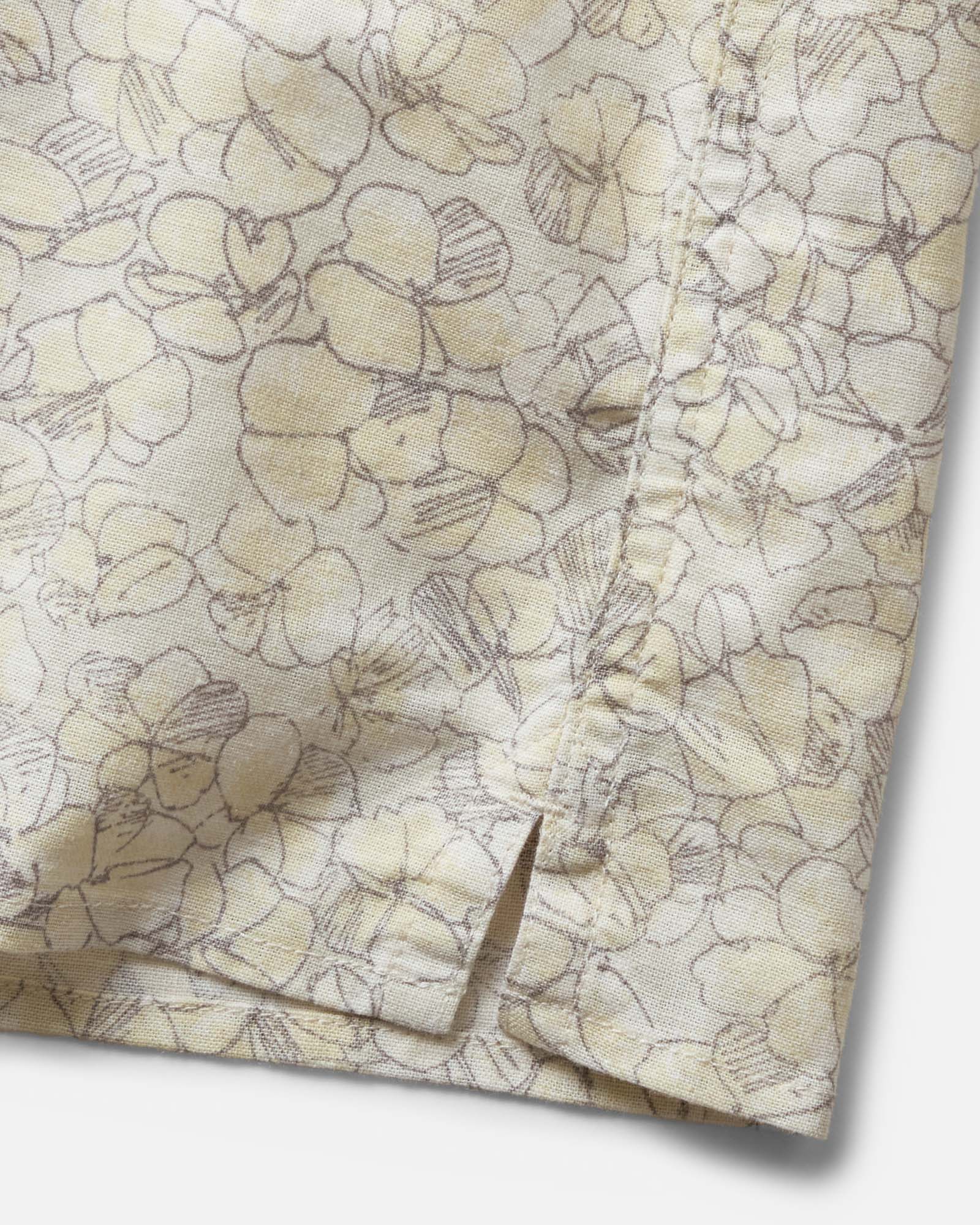 material shot of the hem on The Davis Shirt in Grey Skies Floral, Wovens by Taylor Stitch