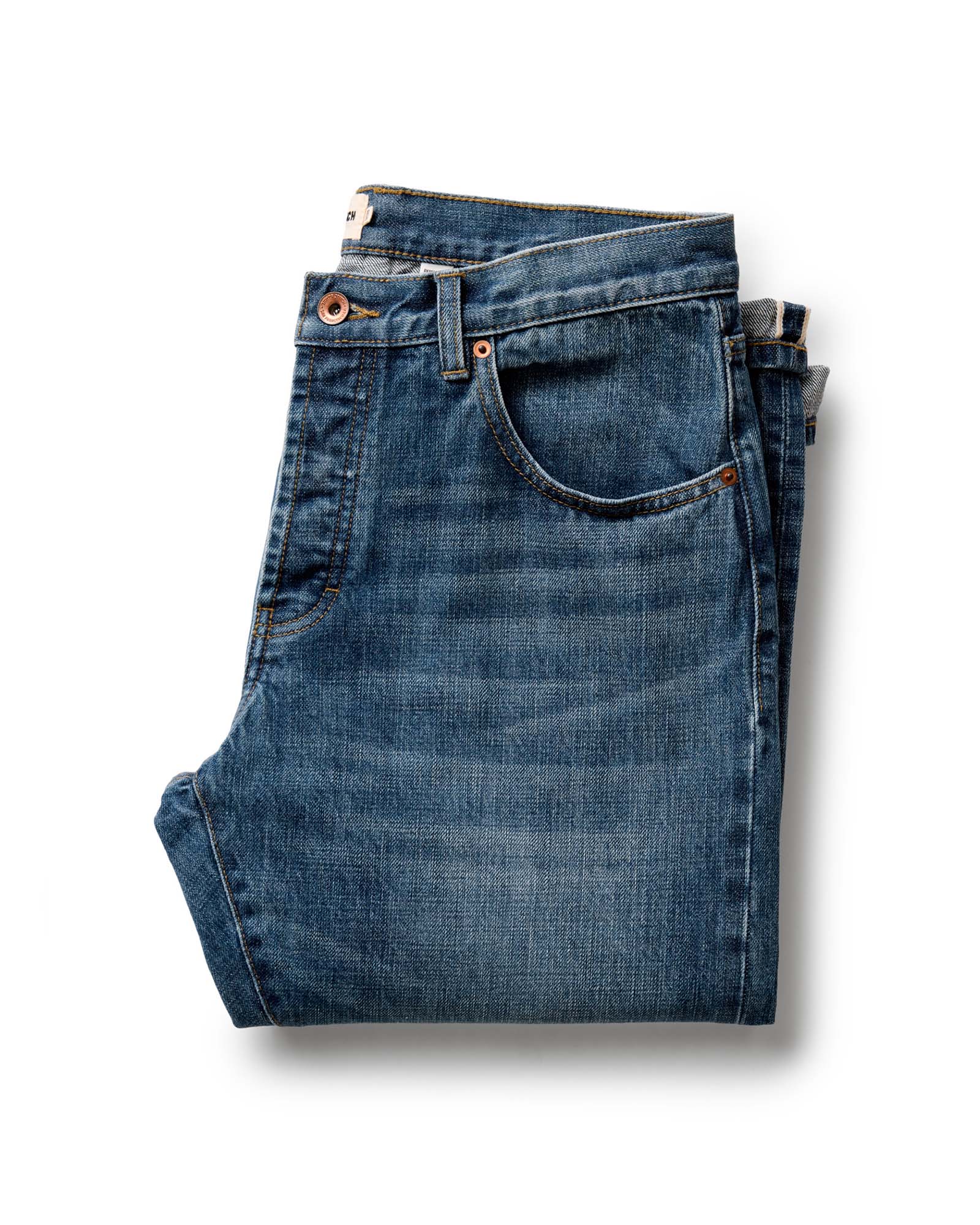 folded flatlay of The Democratic Jean in Mid Wash Organic Selvedge, Bottoms by Taylor Stitch