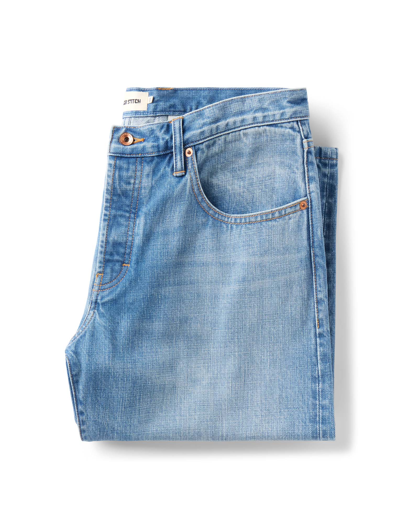 folded flatlay of The Democratic Jean in Light Wash Organic Selvedge, Bottoms by Taylor Stitch