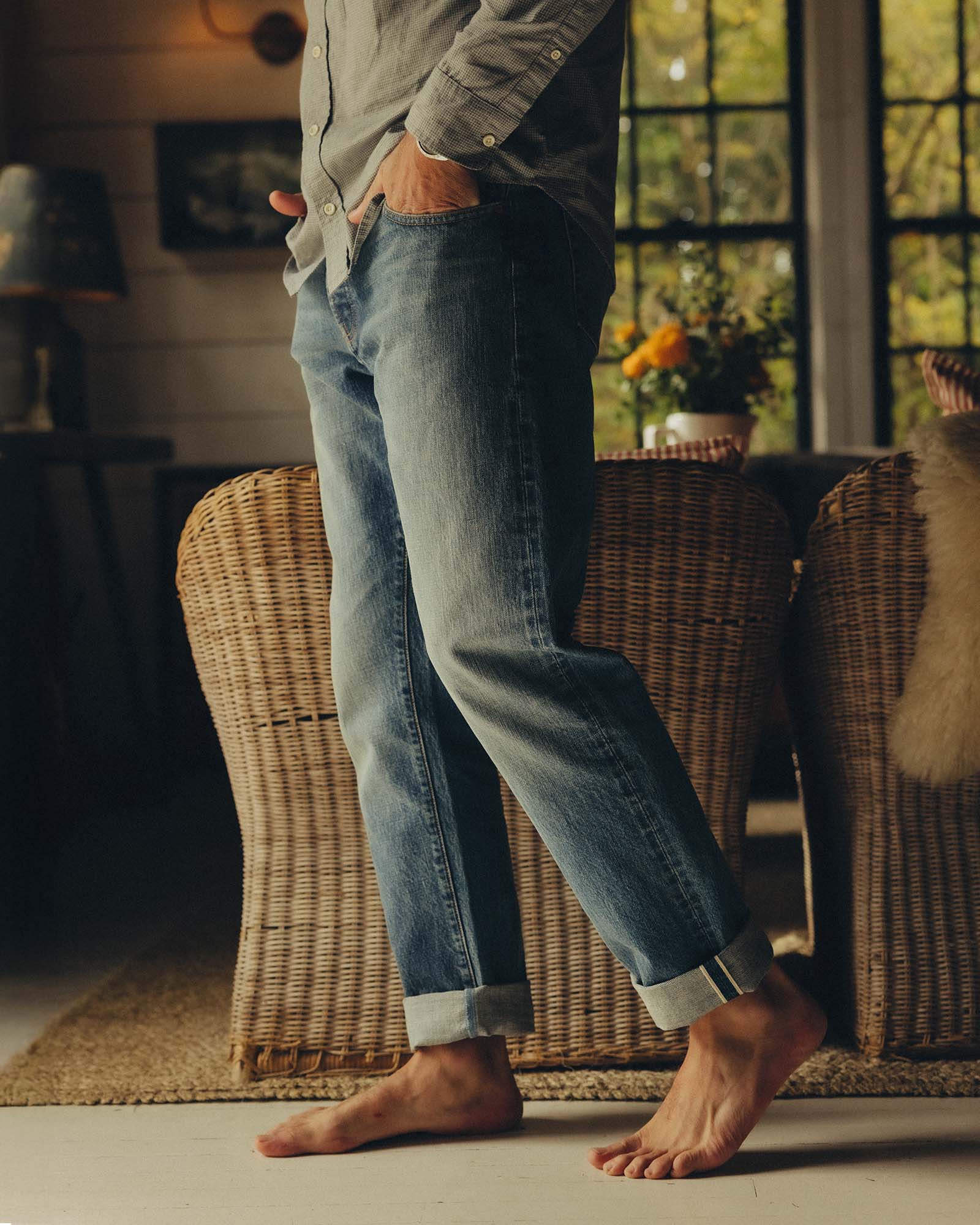 fit model walking wearing The Democratic Jean in Light Wash Organic Selvedge, Bottoms by Taylor Stitch