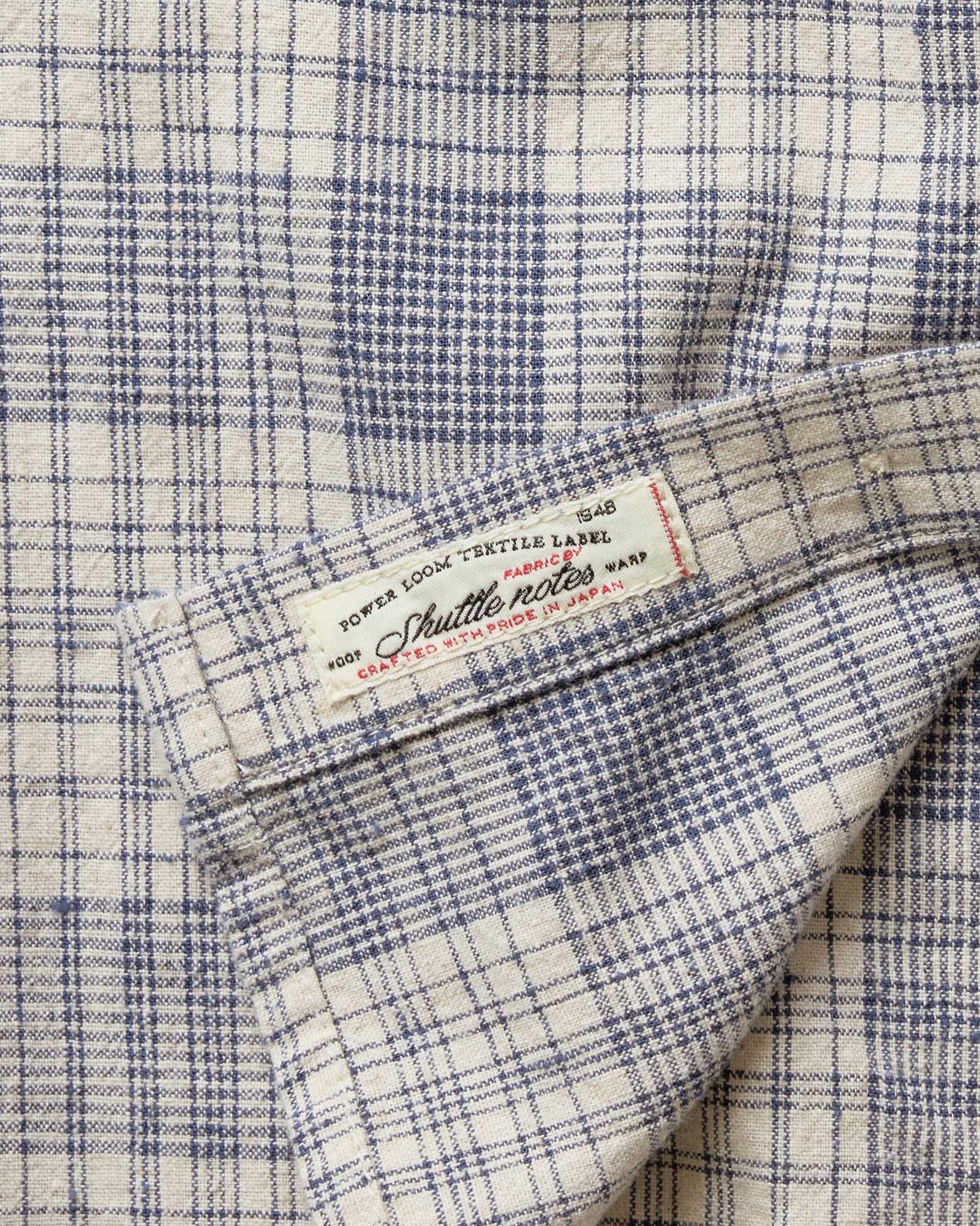 material shot of the tag on The Jack in Japanese Oyster Plaid, Wovens by Taylor Stitch