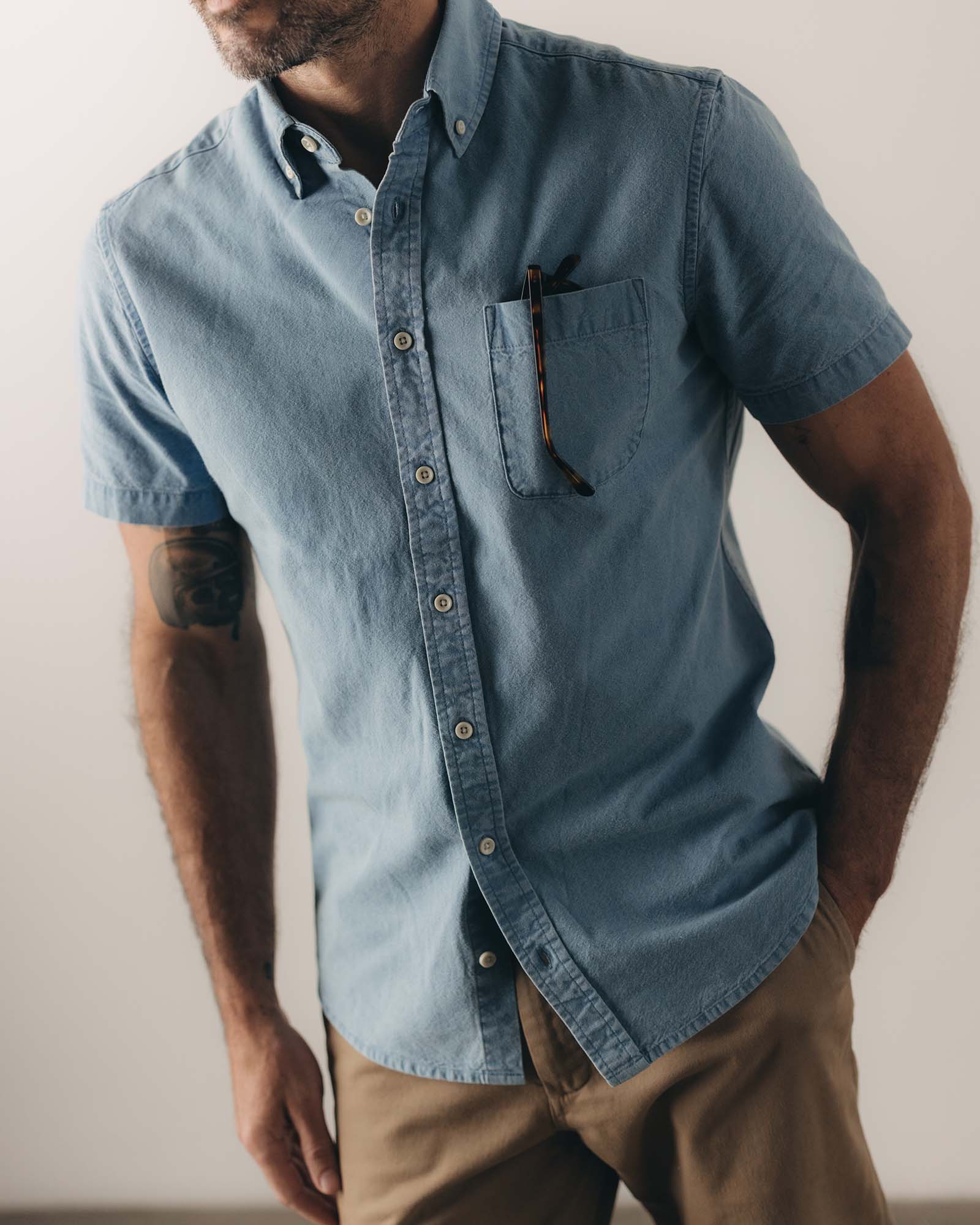 fit model posing in The Short Sleeve Jack in Washed Indigo Oxford, Wovens by Taylor Stitch