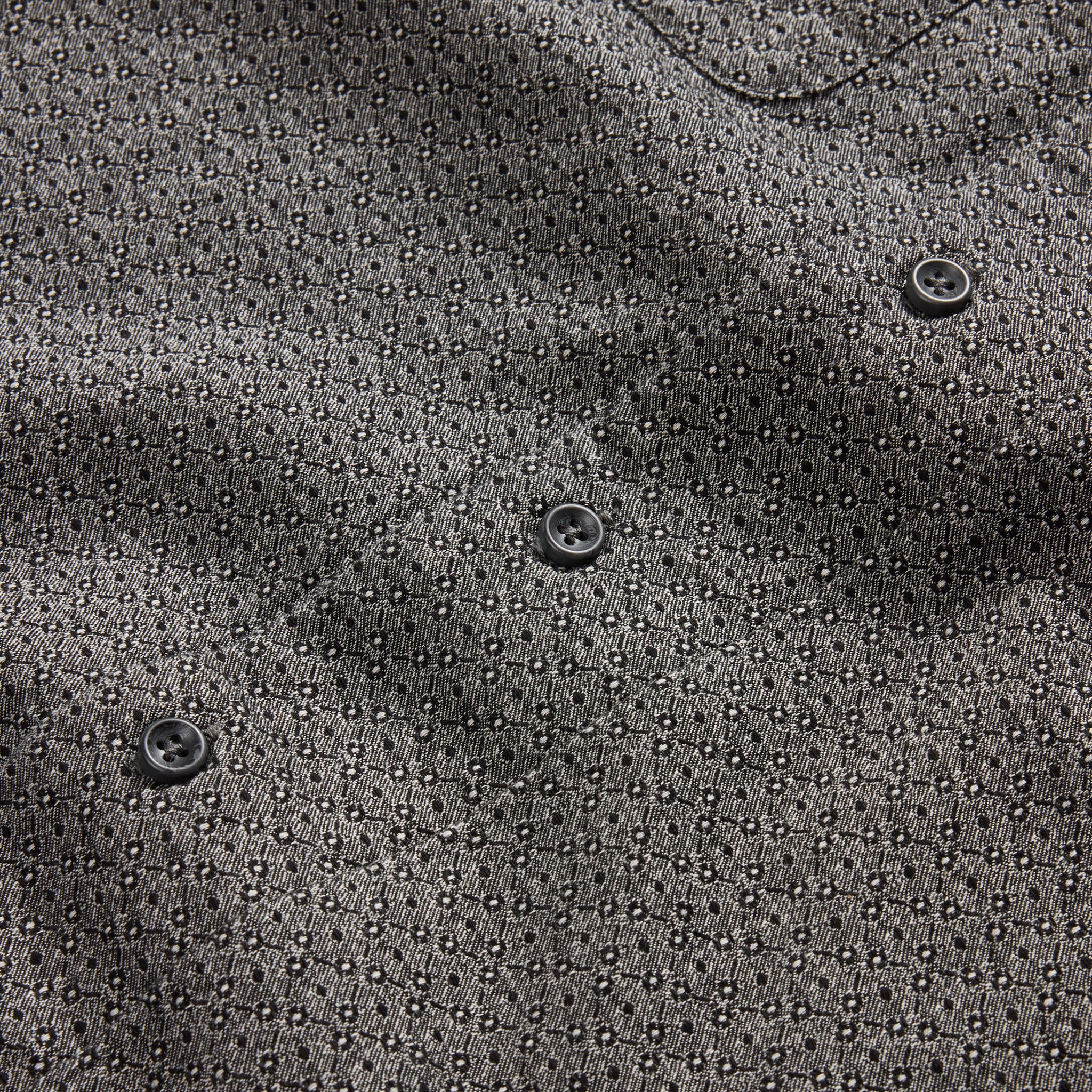 material shot of the charcoal buttons on The Conrad in Black Indigo Jacquard Floral, Wovens by Taylor Stitch