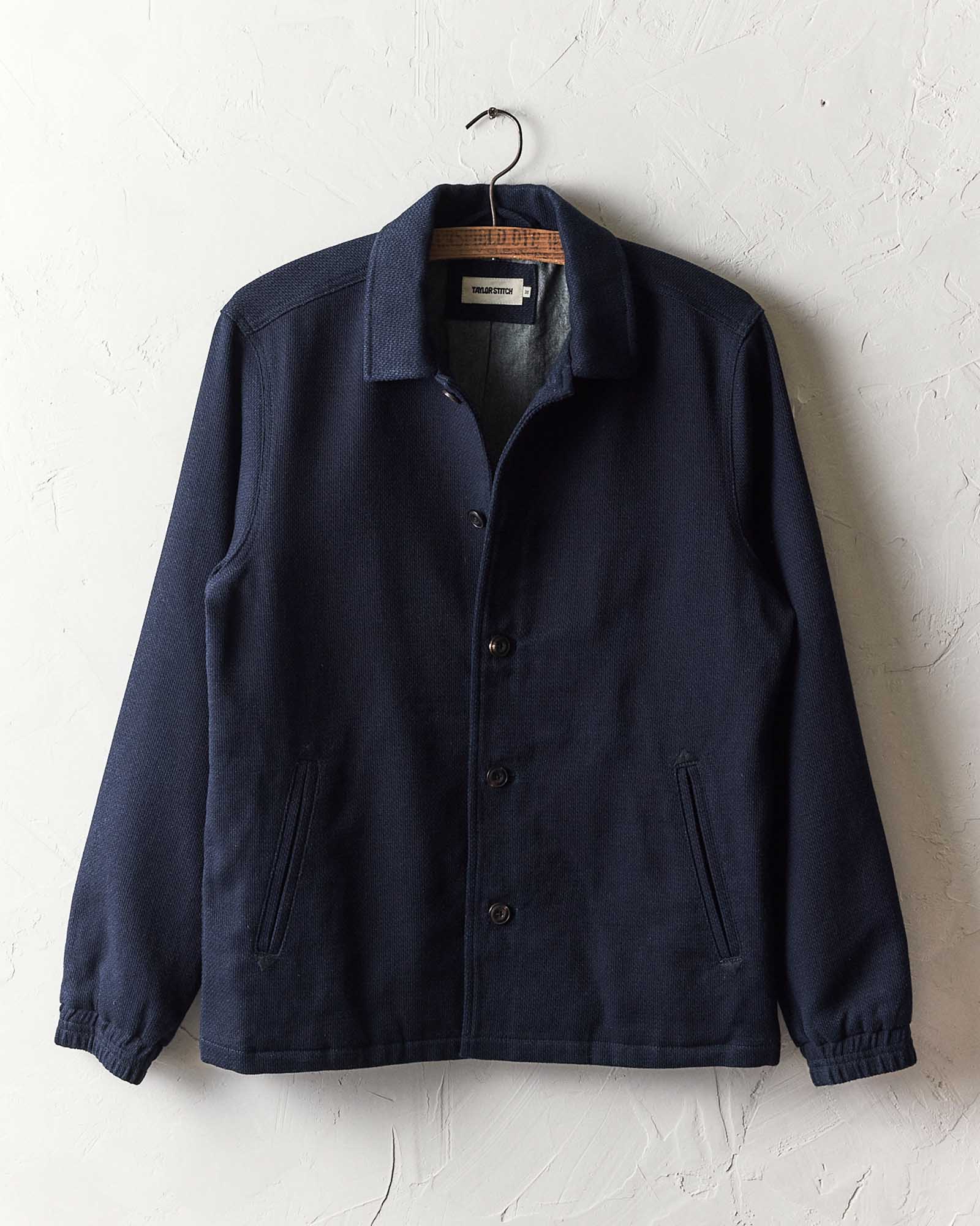 editorial image of The Crew Jacket in Raw Indigo Sashiko hanging, Outerwear by Taylor Stitch