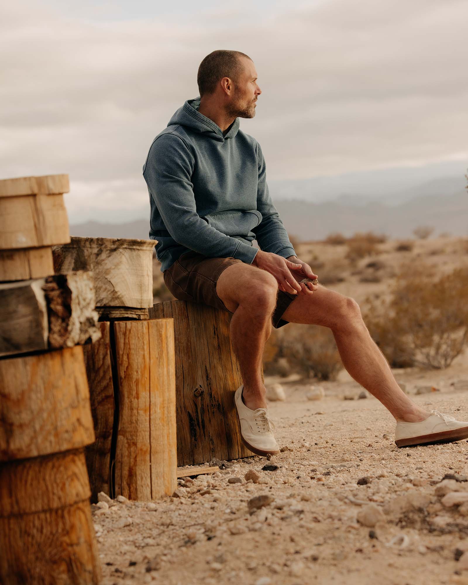 fit model sitting wearing The Apres Hoodie in Washed Indigo Terry, Knits by Taylor Stitch