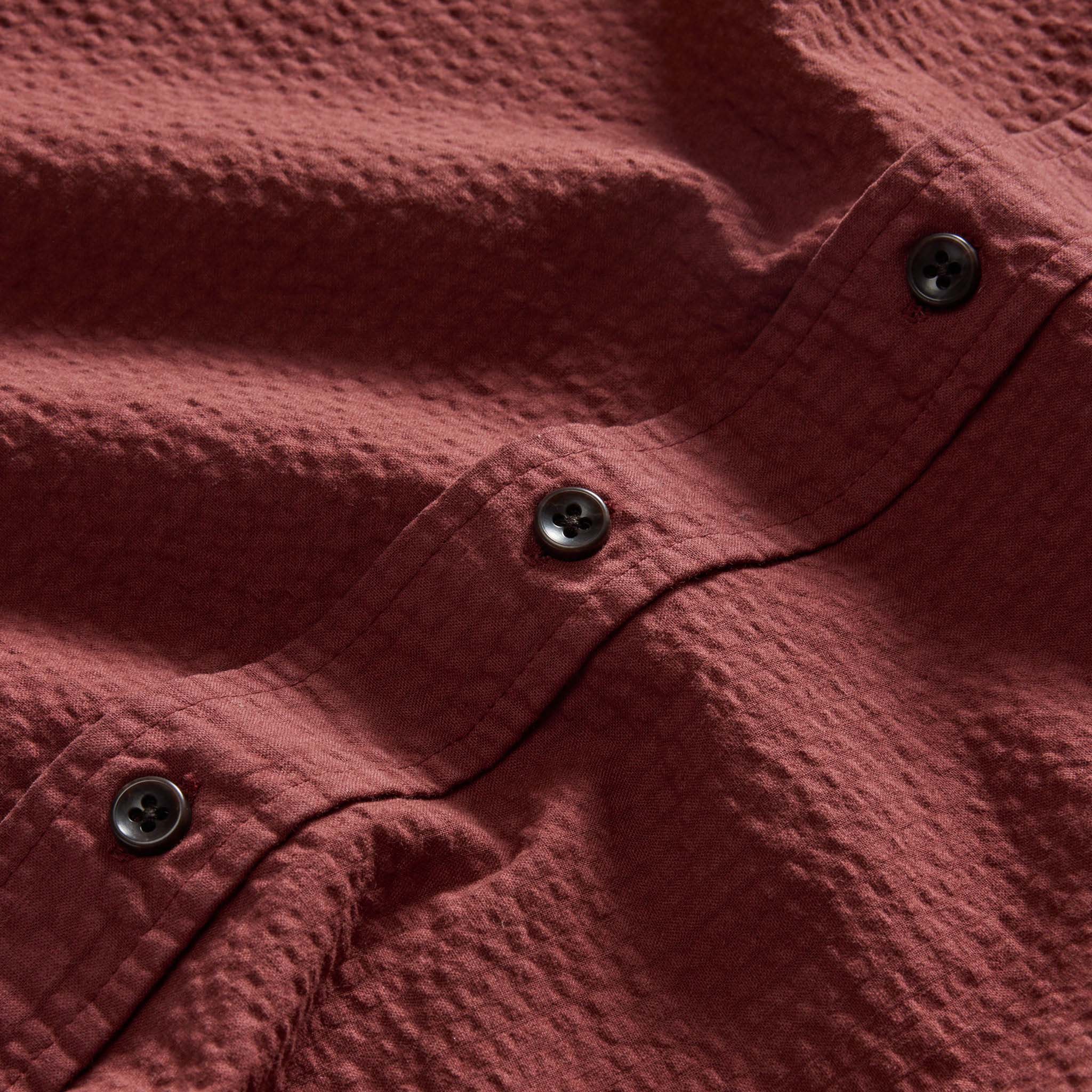 material shot of the buttons on The Short Sleeve Jack in Dried Cherry Seersucker, Wovens by Taylor Stitch