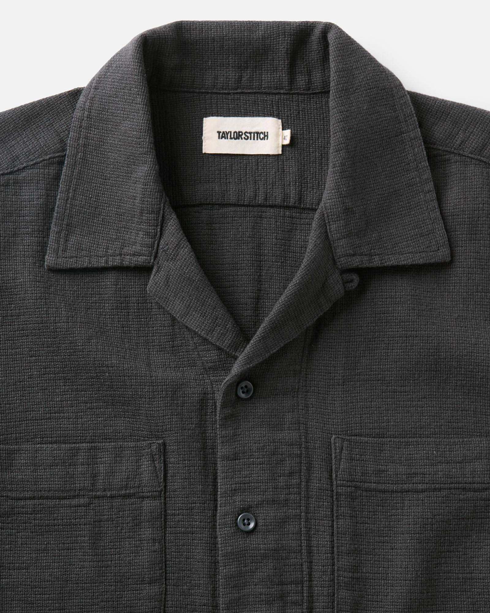 editorial image of The Conrad Shirt in Faded Black Linen hanging on a painting, Wovens by Taylor Stitch