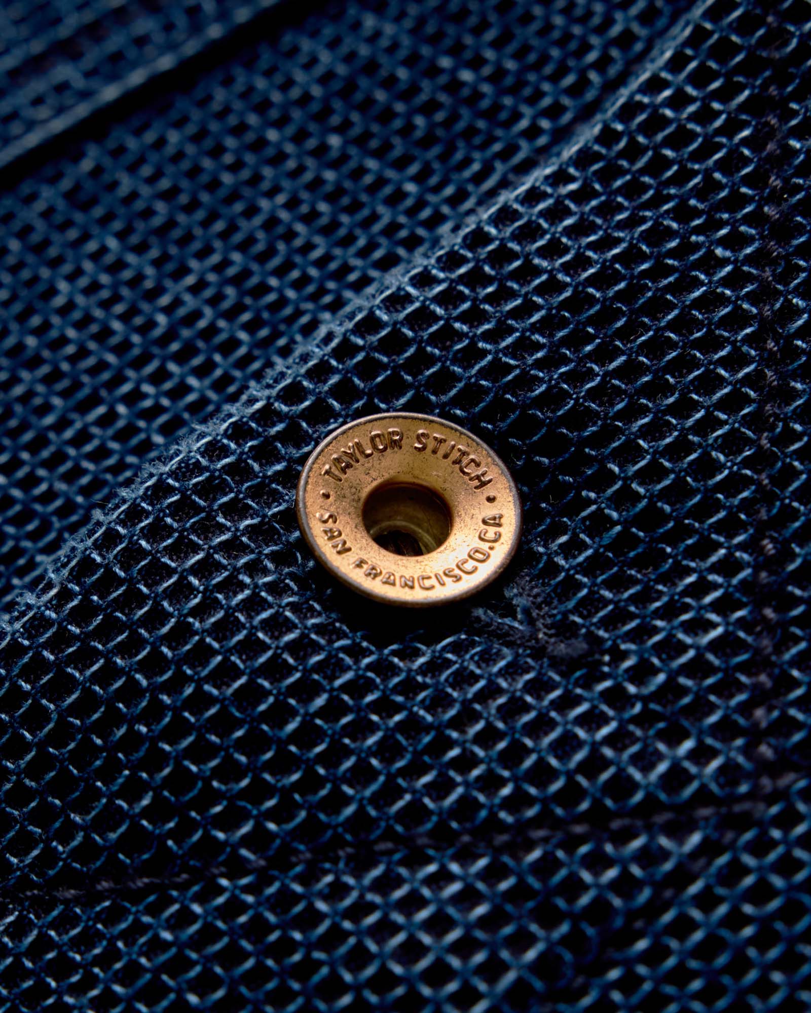 Close up of the leather label on The Long Haul Jacket in Rinsed Indigo Waffle, Outerwear by Taylor Stitch