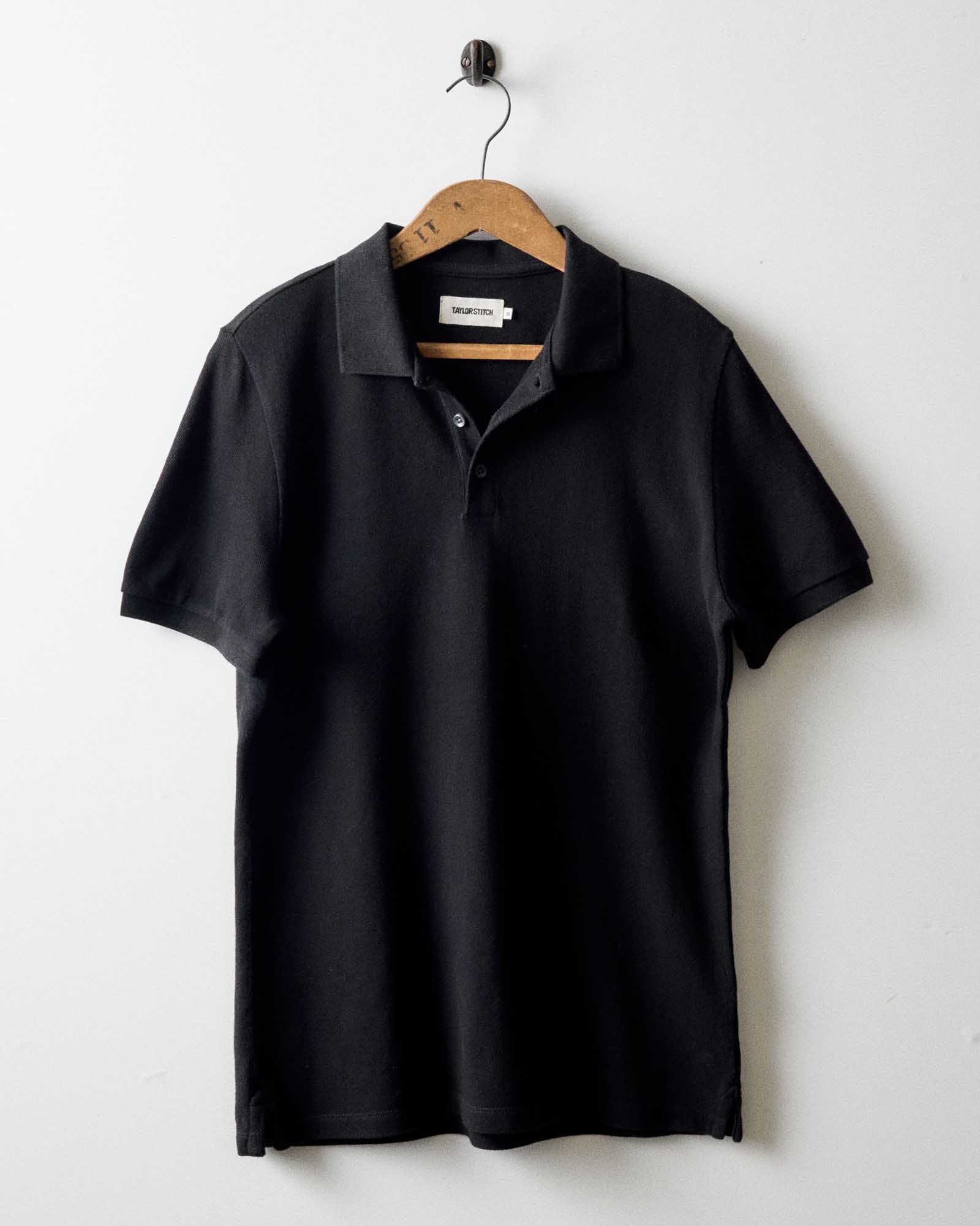 editorial image of The Pacific Polo in Black Indigo Pique hanging, Knits by Taylor Stitch