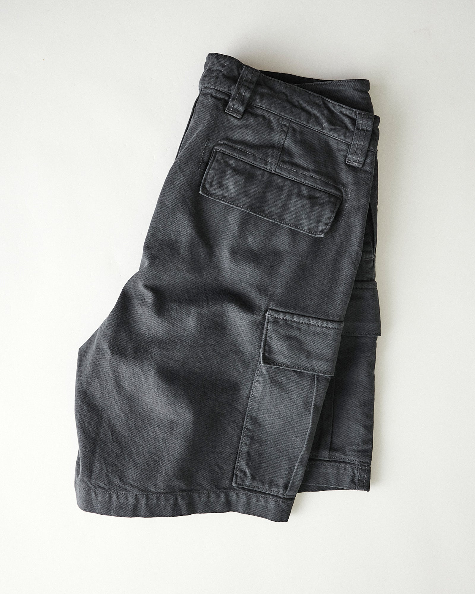 folded flatlay of The Tommie Short in Faded Black Broken Twill, Bottoms by Taylor Stitch
