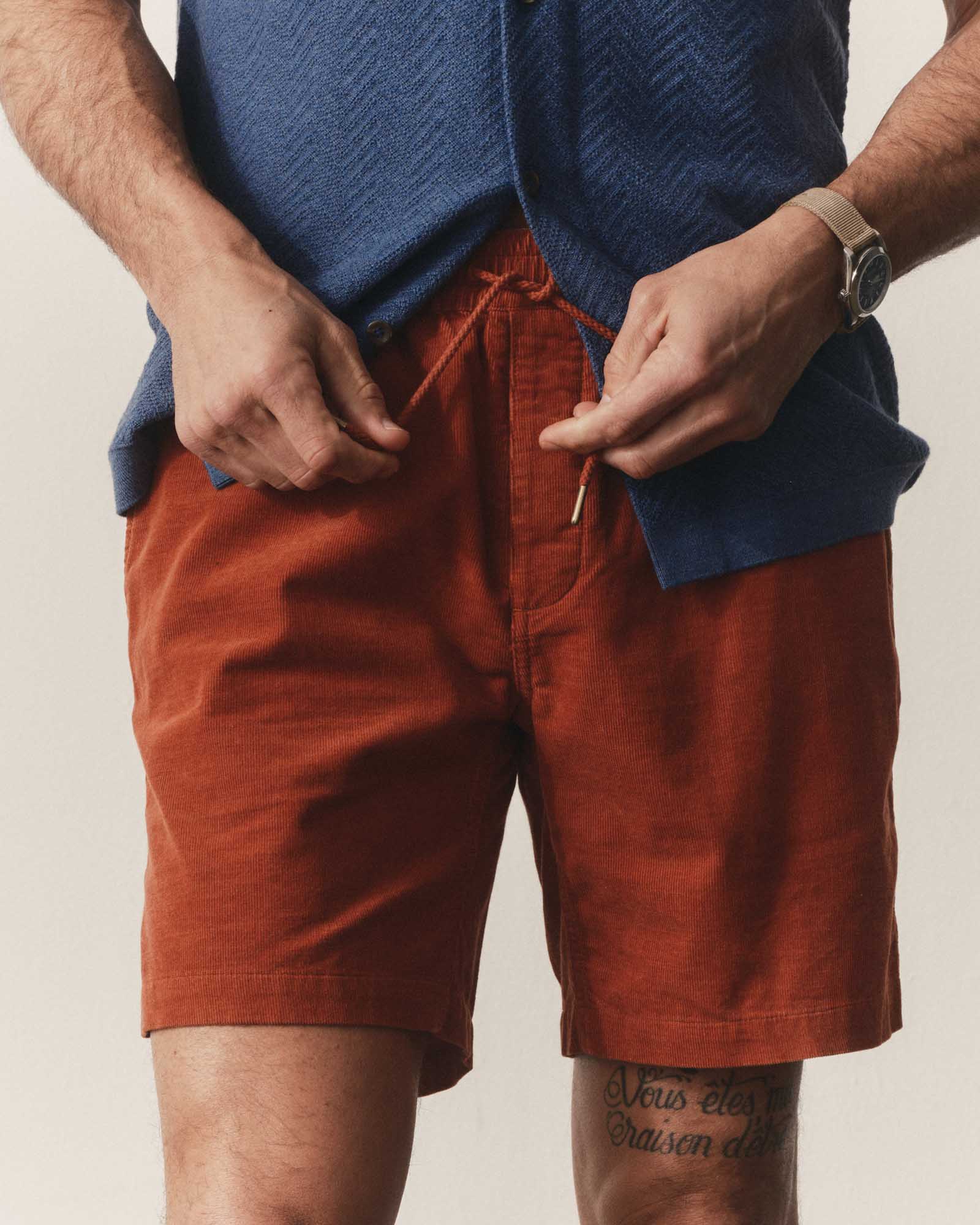 fit model tying the waistband on The Apres Short in Heather Chili Pincord, Bottoms by Taylor Stitch