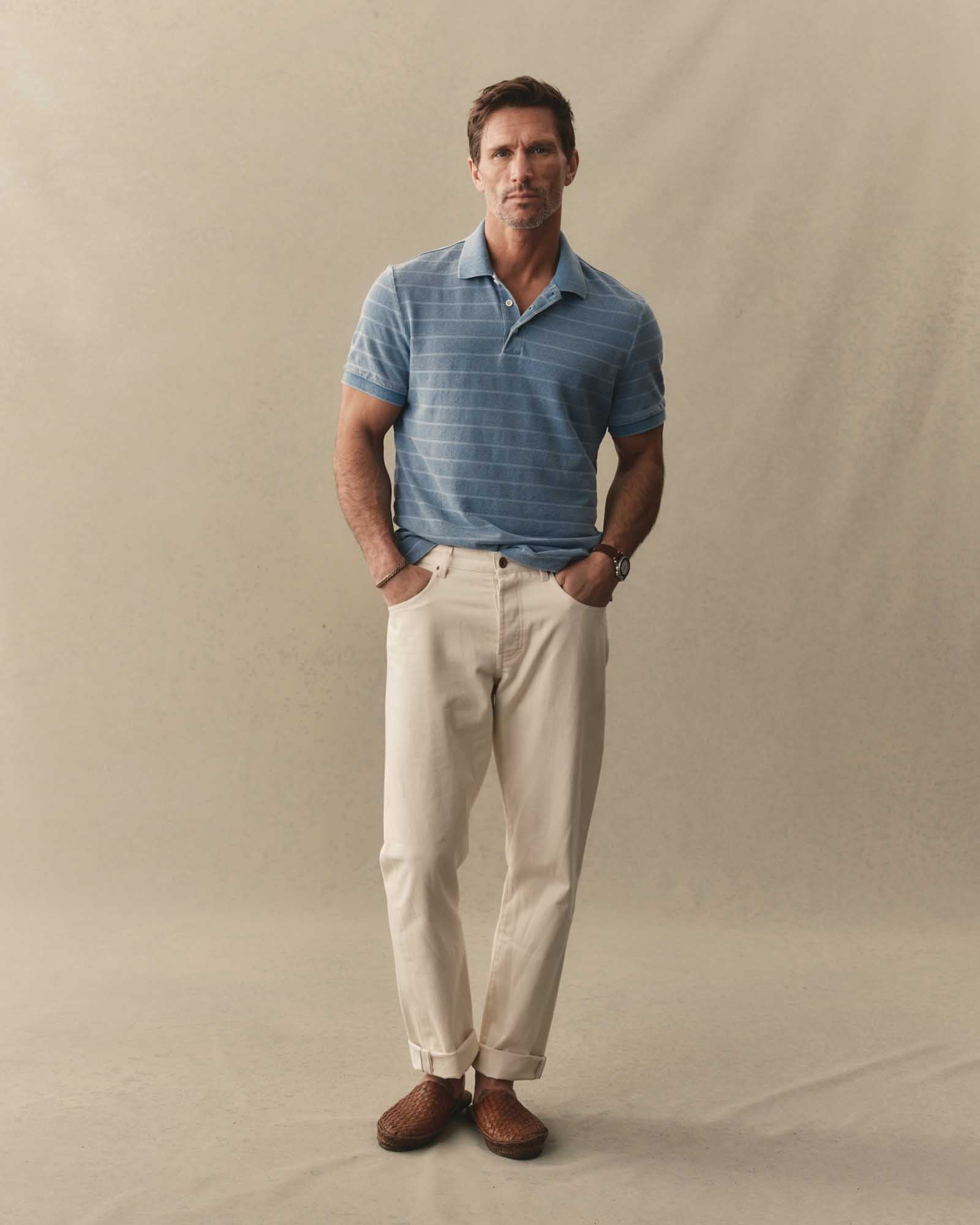 fit model posing in The Pacific Polo in Washed Indigo Pique Stripe, Knits by Taylor Stitch