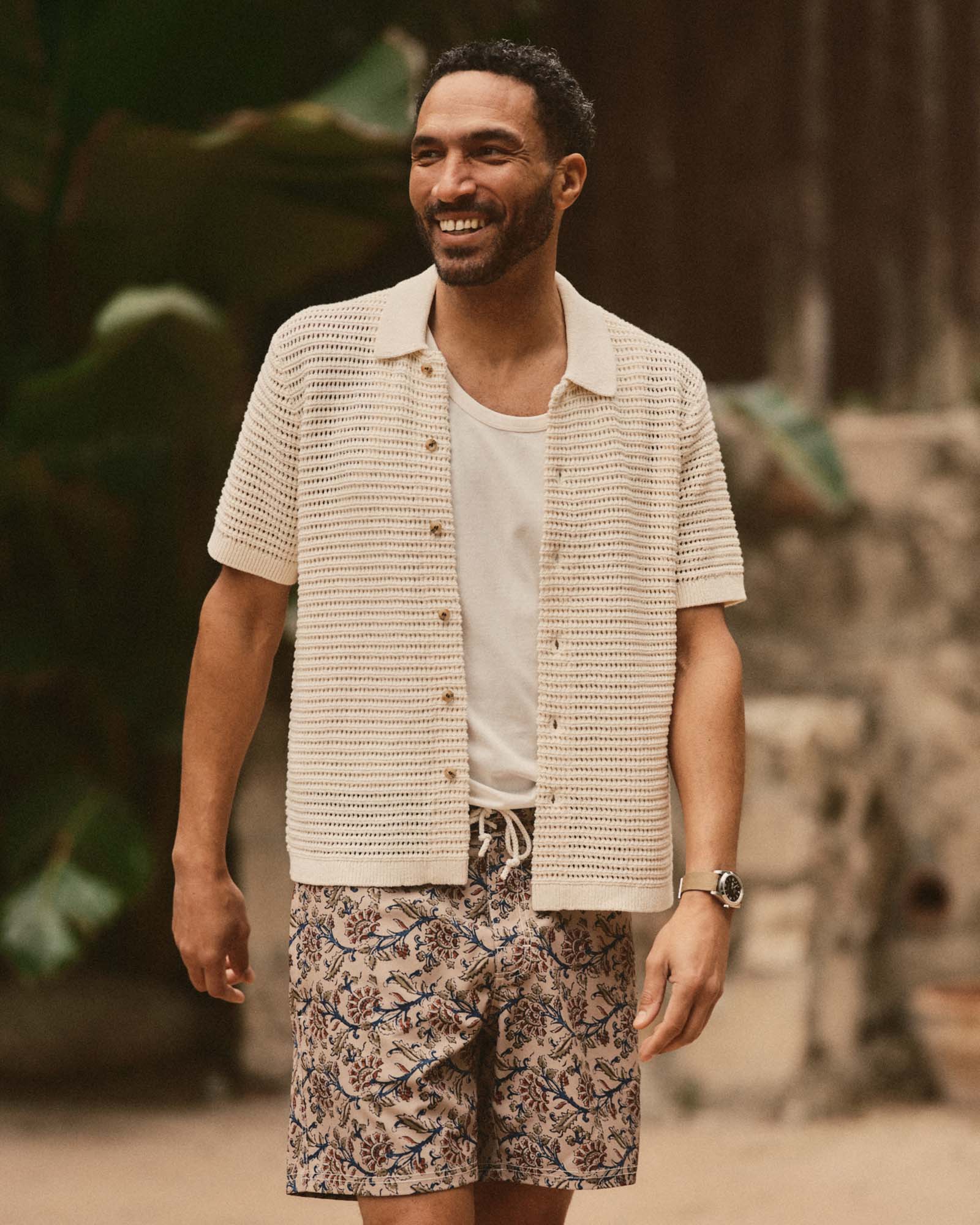 fit model walking wearing The Monterey Sweater Polo in Vintage White Crochet, Knits by Taylor Stitch