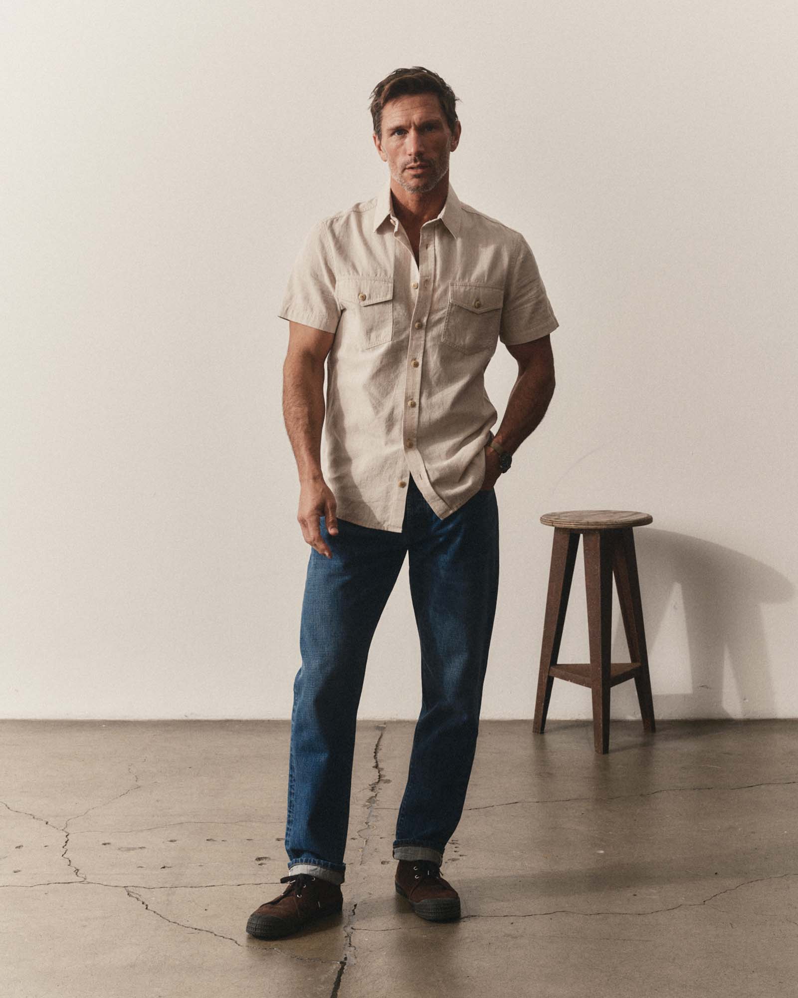fit model posing in The Short Sleeve Crew Shirt in Natural Chambray, Wovens by Taylor Stitch