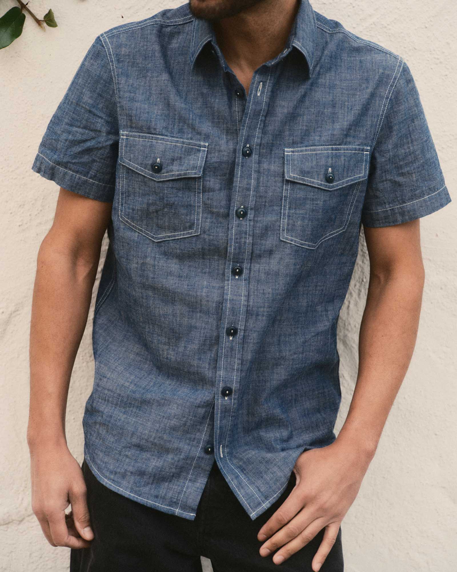 fit model posing in The Short Sleeve Crew Shirt in Washed Indigo Chambray, Wovens by Taylor Stitch