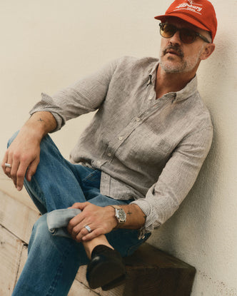 fit model sitting wearing The Jack in Burgundy University Stripe Linen