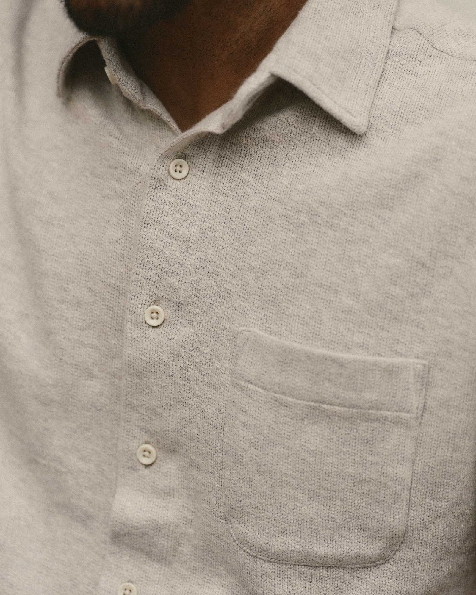 fit model showing off the buttons on The Short Sleeve California in Heather Oat Double Knit, Knits by Taylor Stitch