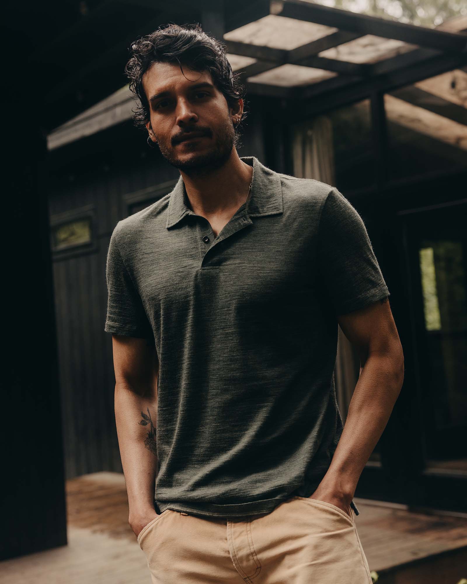 fit model posing in The Merino Polo in Heather Army, Knits by Taylor Stitch