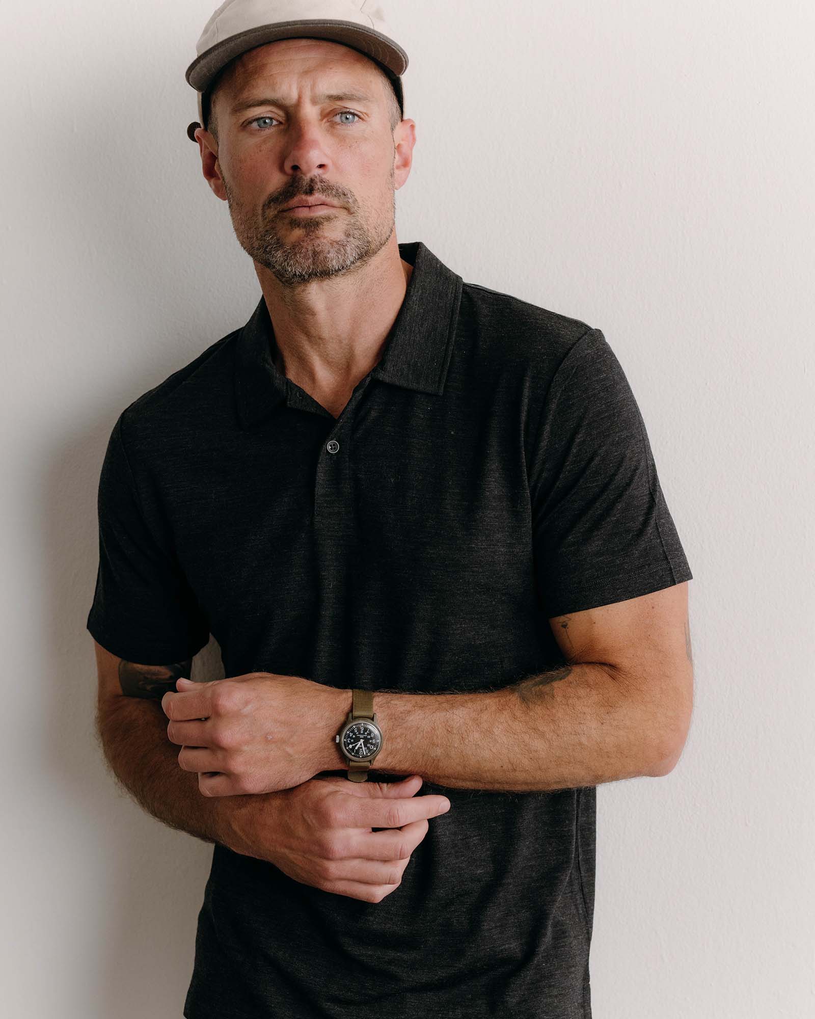 fit model posing in The Merino Polo in Heather Black, Knits by Taylor Stitch